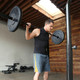 45 lb. olympic barbell by SteelBody will complete your home gym in use by model - squat